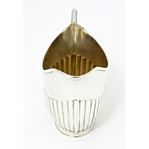 303 - A Victorian silver cream jug with fluted detail, hallmarked Sheffield 1894, maker John Round & Son L... 