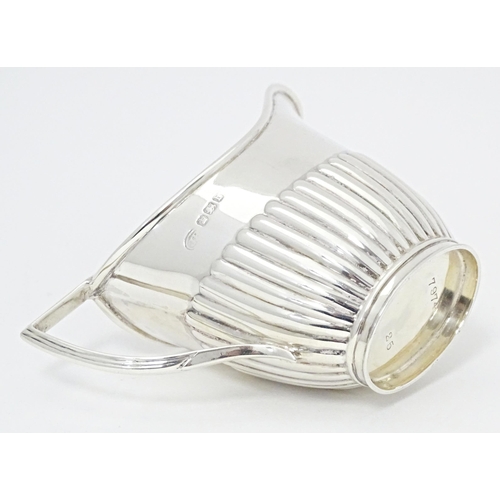 303 - A Victorian silver cream jug with fluted detail, hallmarked Sheffield 1894, maker John Round & Son L... 