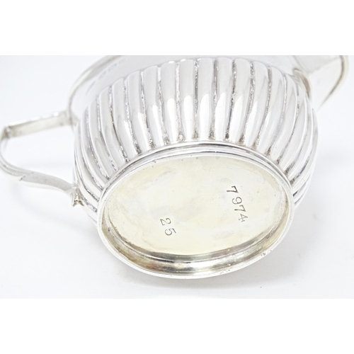 303 - A Victorian silver cream jug with fluted detail, hallmarked Sheffield 1894, maker John Round & Son L... 