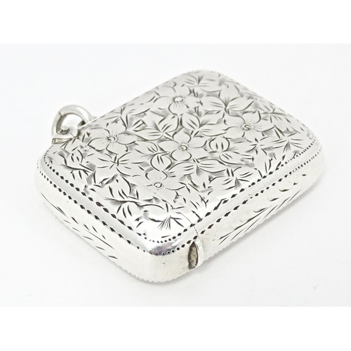 305 - A Victorian silver vesta case with engraved floral and foliate detail, hallmarked Birmingham 1898, m... 