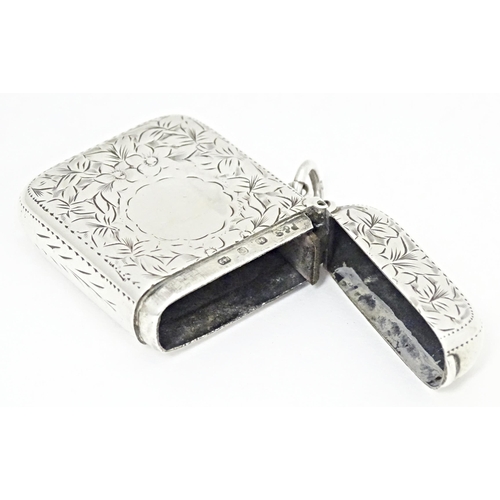 305 - A Victorian silver vesta case with engraved floral and foliate detail, hallmarked Birmingham 1898, m... 