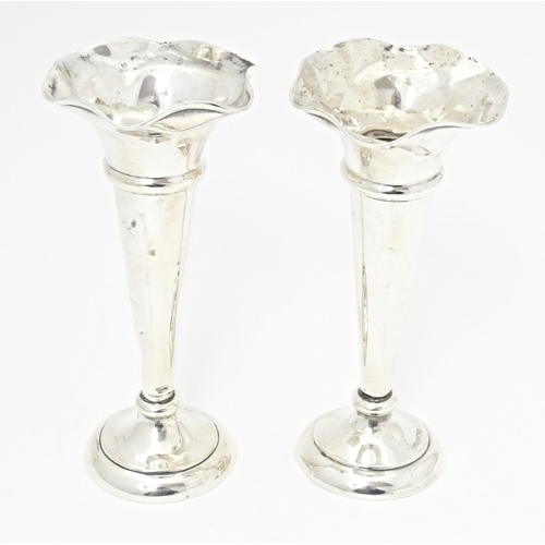 310 - A pair of silver bud vases with fluted rims, hallmarked Sheffield 1920, maker Walker & Hall. Approx.... 