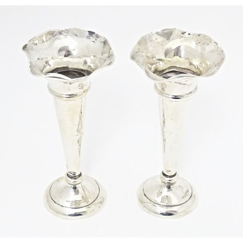 310 - A pair of silver bud vases with fluted rims, hallmarked Sheffield 1920, maker Walker & Hall. Approx.... 