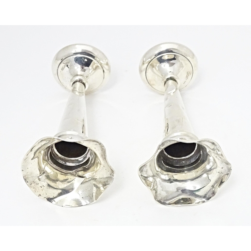 310 - A pair of silver bud vases with fluted rims, hallmarked Sheffield 1920, maker Walker & Hall. Approx.... 