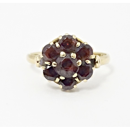 590 - A 9ct gold ring set with garnet cluster. Ring size approx. L