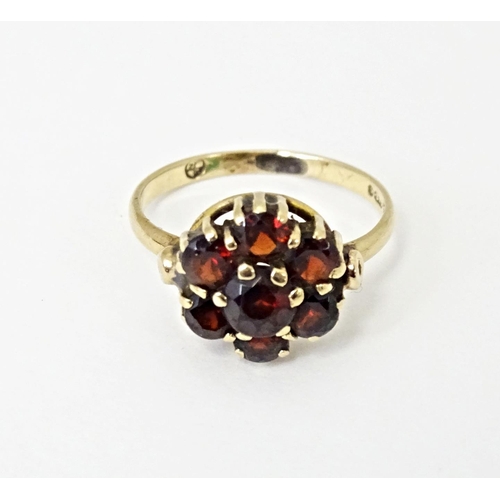 590 - A 9ct gold ring set with garnet cluster. Ring size approx. L