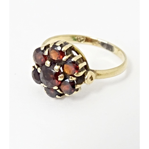 590 - A 9ct gold ring set with garnet cluster. Ring size approx. L