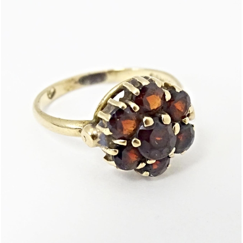 590 - A 9ct gold ring set with garnet cluster. Ring size approx. L