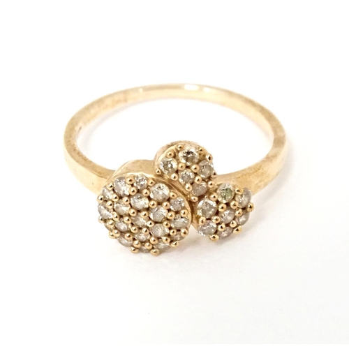 592 - A 9ct rose gold ring set with a profusion of Argyle diamonds. Ring size approx. N