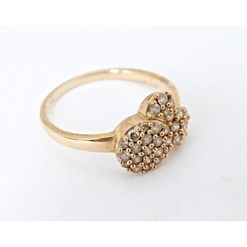 592 - A 9ct rose gold ring set with a profusion of Argyle diamonds. Ring size approx. N