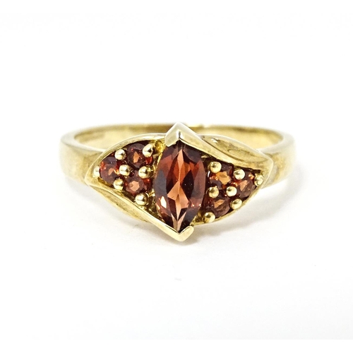 594 - A 9ct gold ring set with garnets. Ring size approx. N