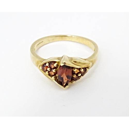 594 - A 9ct gold ring set with garnets. Ring size approx. N