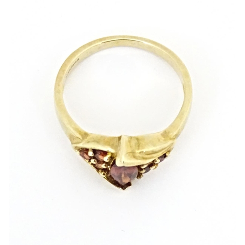 594 - A 9ct gold ring set with garnets. Ring size approx. N