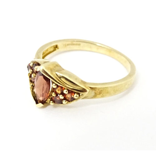 594 - A 9ct gold ring set with garnets. Ring size approx. N