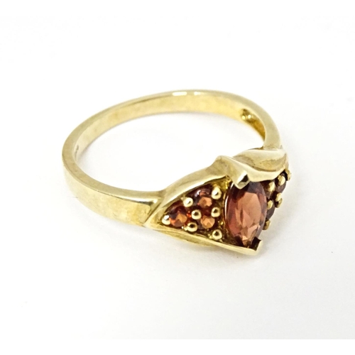 594 - A 9ct gold ring set with garnets. Ring size approx. N