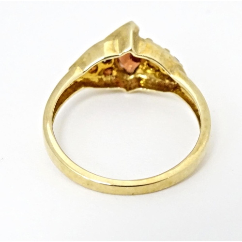 594 - A 9ct gold ring set with garnets. Ring size approx. N