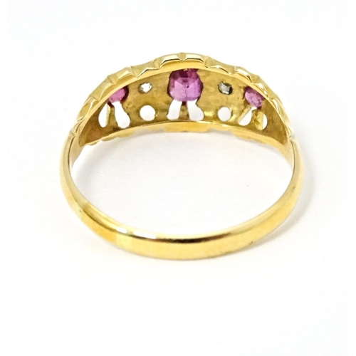 597 - An 18ct gold ring set with three rubies and two diamonds, hallmarked Birmingham 1915. Ring size appr... 