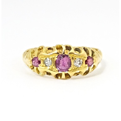 597 - An 18ct gold ring set with three rubies and two diamonds, hallmarked Birmingham 1915. Ring size appr... 