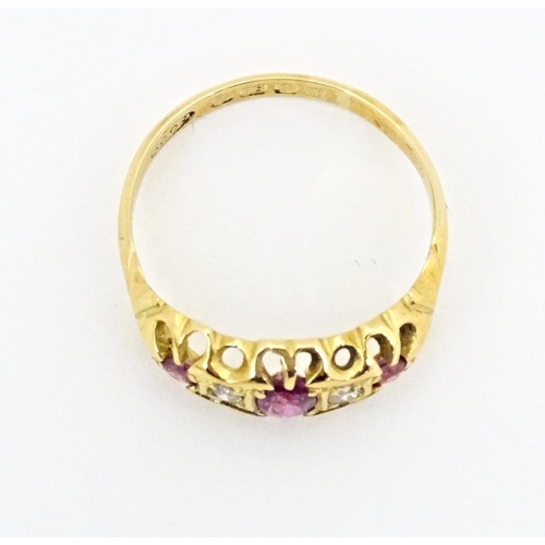 597 - An 18ct gold ring set with three rubies and two diamonds, hallmarked Birmingham 1915. Ring size appr... 