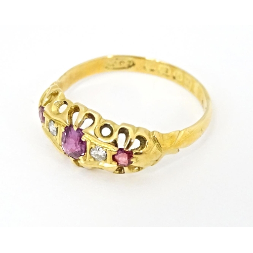 597 - An 18ct gold ring set with three rubies and two diamonds, hallmarked Birmingham 1915. Ring size appr... 