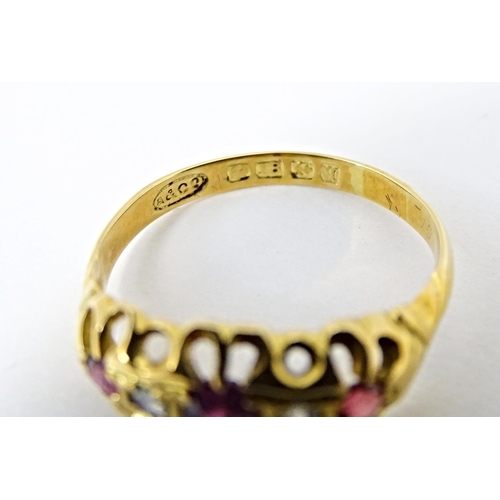 597 - An 18ct gold ring set with three rubies and two diamonds, hallmarked Birmingham 1915. Ring size appr... 