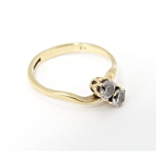 602 - A 9ct gold ring set with two white stones. Ring size approx. N