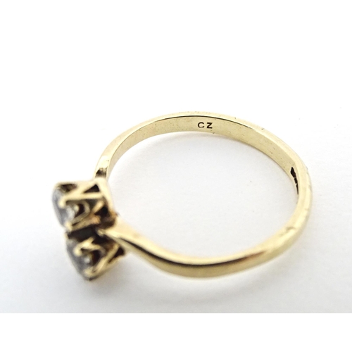 602 - A 9ct gold ring set with two white stones. Ring size approx. N