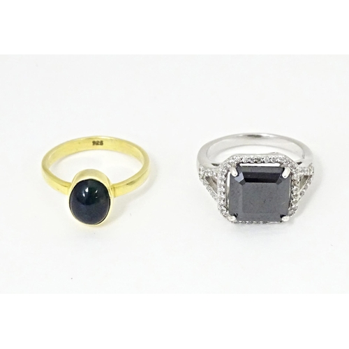 605 - A silver dress ring. Together with a silver gilt dress ring. Ring sizes approx. L (2)