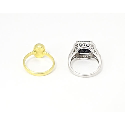 605 - A silver dress ring. Together with a silver gilt dress ring. Ring sizes approx. L (2)