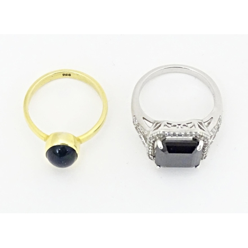 605 - A silver dress ring. Together with a silver gilt dress ring. Ring sizes approx. L (2)