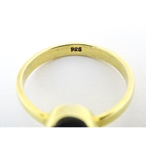 605 - A silver dress ring. Together with a silver gilt dress ring. Ring sizes approx. L (2)