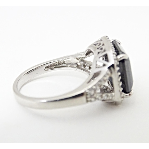 605 - A silver dress ring. Together with a silver gilt dress ring. Ring sizes approx. L (2)