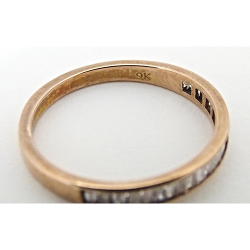 620 - A 9ct rose gold half eternity ring set with pink diamonds. Ring size approx. R