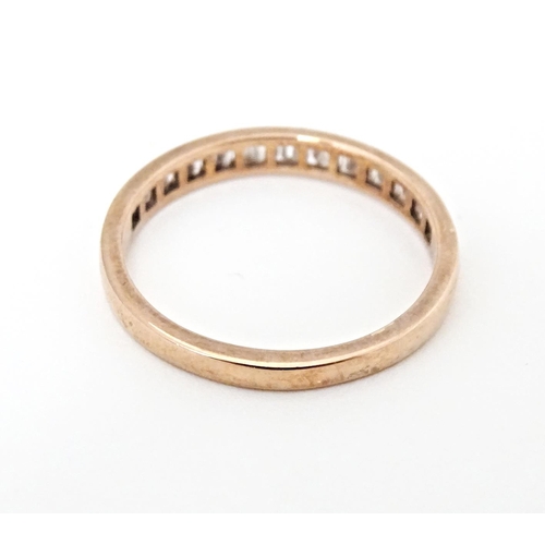 620 - A 9ct rose gold half eternity ring set with pink diamonds. Ring size approx. R