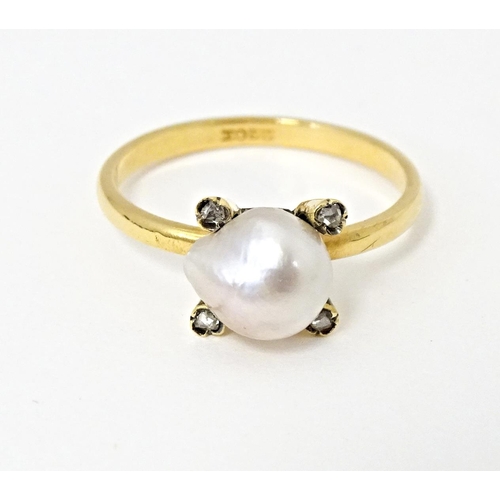 621 - A 22ct gold ring set with central pearl bordered by four diamonds. Ring size approx. S