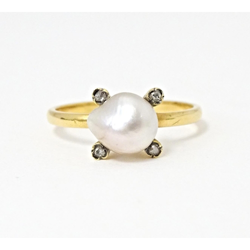 621 - A 22ct gold ring set with central pearl bordered by four diamonds. Ring size approx. S