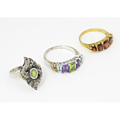 624 - Three silver dress rings comprising silver gilt & garnet, silver & marcasite, and amethyst, aquamari... 