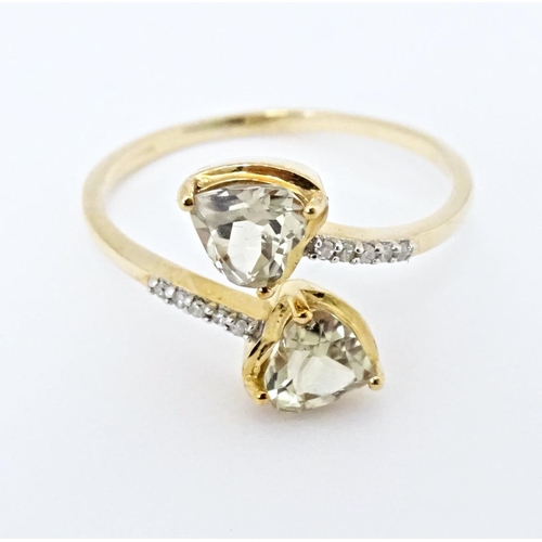 626 - A 9ct gold ring set with two Csarite of heart form flanked by diamonds. Together with a similar pend... 