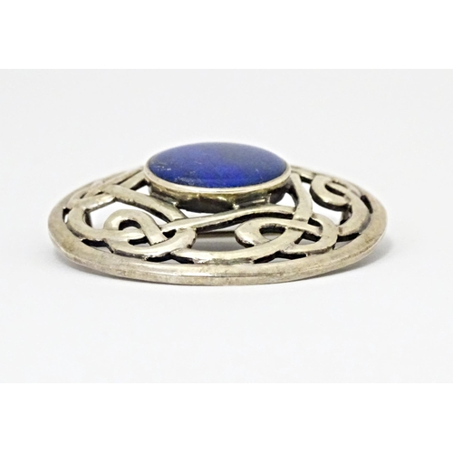 627 - A silver brooch of circular form with Celtic style decoration set central blue cabochon. Approx. 1 3... 