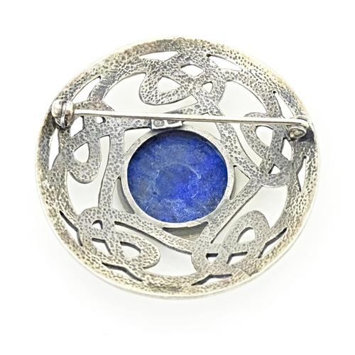 627 - A silver brooch of circular form with Celtic style decoration set central blue cabochon. Approx. 1 3... 