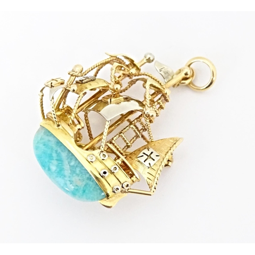 628 - An 18ct gold pendant / brooch formed as a three mast sailing ship set with green amazonite style sto... 