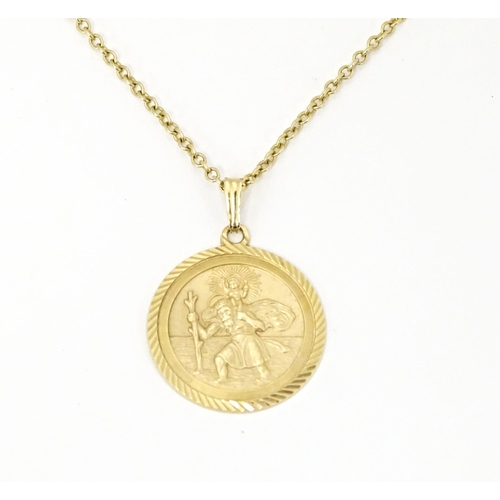 629 - A 9ct gold chain with St. Christopher. Chain approx. 18