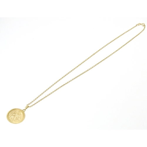 629 - A 9ct gold chain with St. Christopher. Chain approx. 18