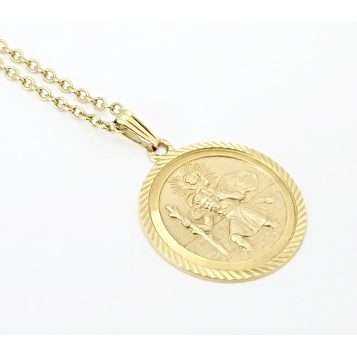 629 - A 9ct gold chain with St. Christopher. Chain approx. 18