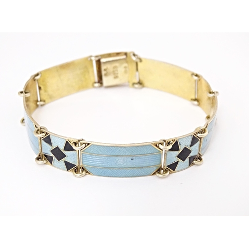 633 - Scandinavian jewellery: A Swedish silver gilt bracelet with pale blue and black guilloche enamel dec... 