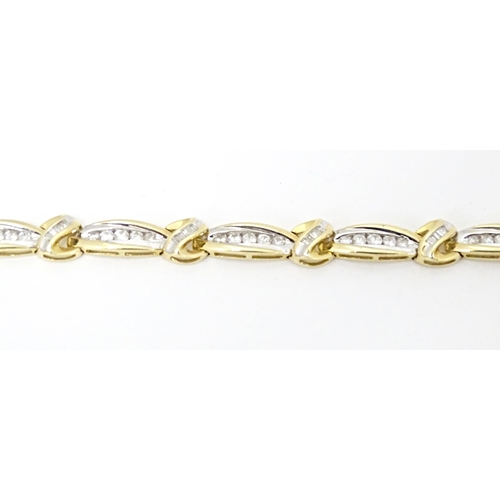 634 - A 9ct gold bracelet set with 50 diamonds interspersed by further bands of diamonds. Marked 10k. Appr... 