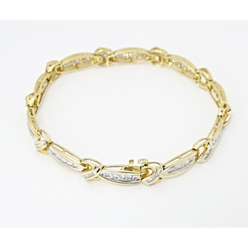 634 - A 9ct gold bracelet set with 50 diamonds interspersed by further bands of diamonds. Marked 10k. Appr... 