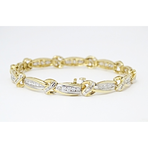 634 - A 9ct gold bracelet set with 50 diamonds interspersed by further bands of diamonds. Marked 10k. Appr... 