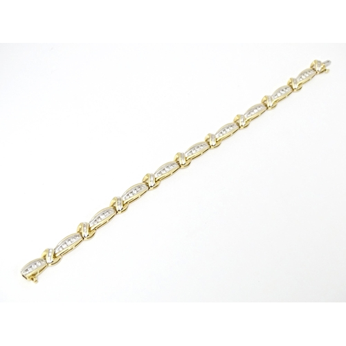 634 - A 9ct gold bracelet set with 50 diamonds interspersed by further bands of diamonds. Marked 10k. Appr... 