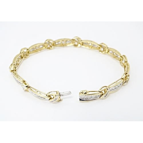 634 - A 9ct gold bracelet set with 50 diamonds interspersed by further bands of diamonds. Marked 10k. Appr... 